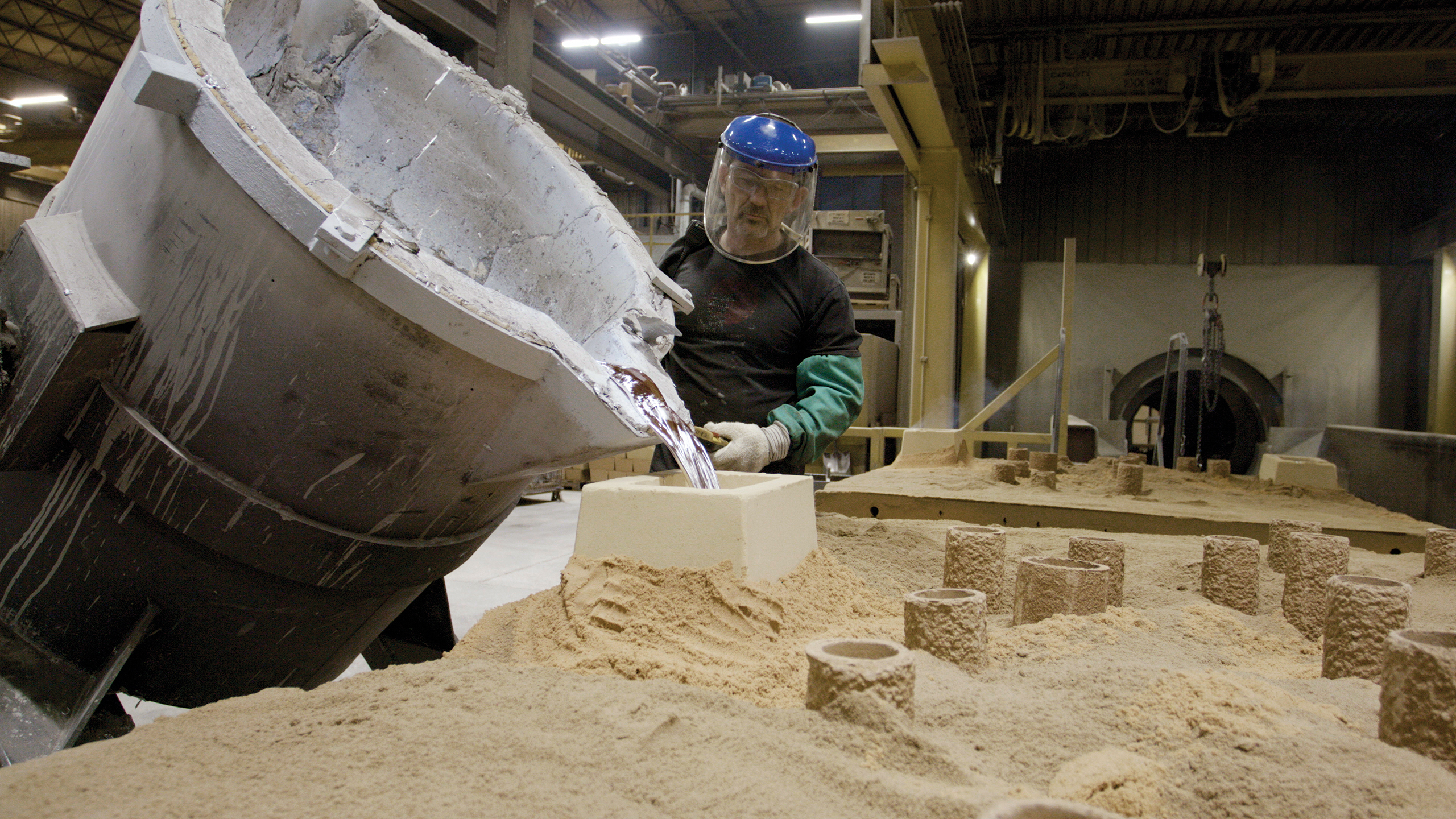 Molten aluminum is poured from a bull ladle into the mold to form the casting at WAF.