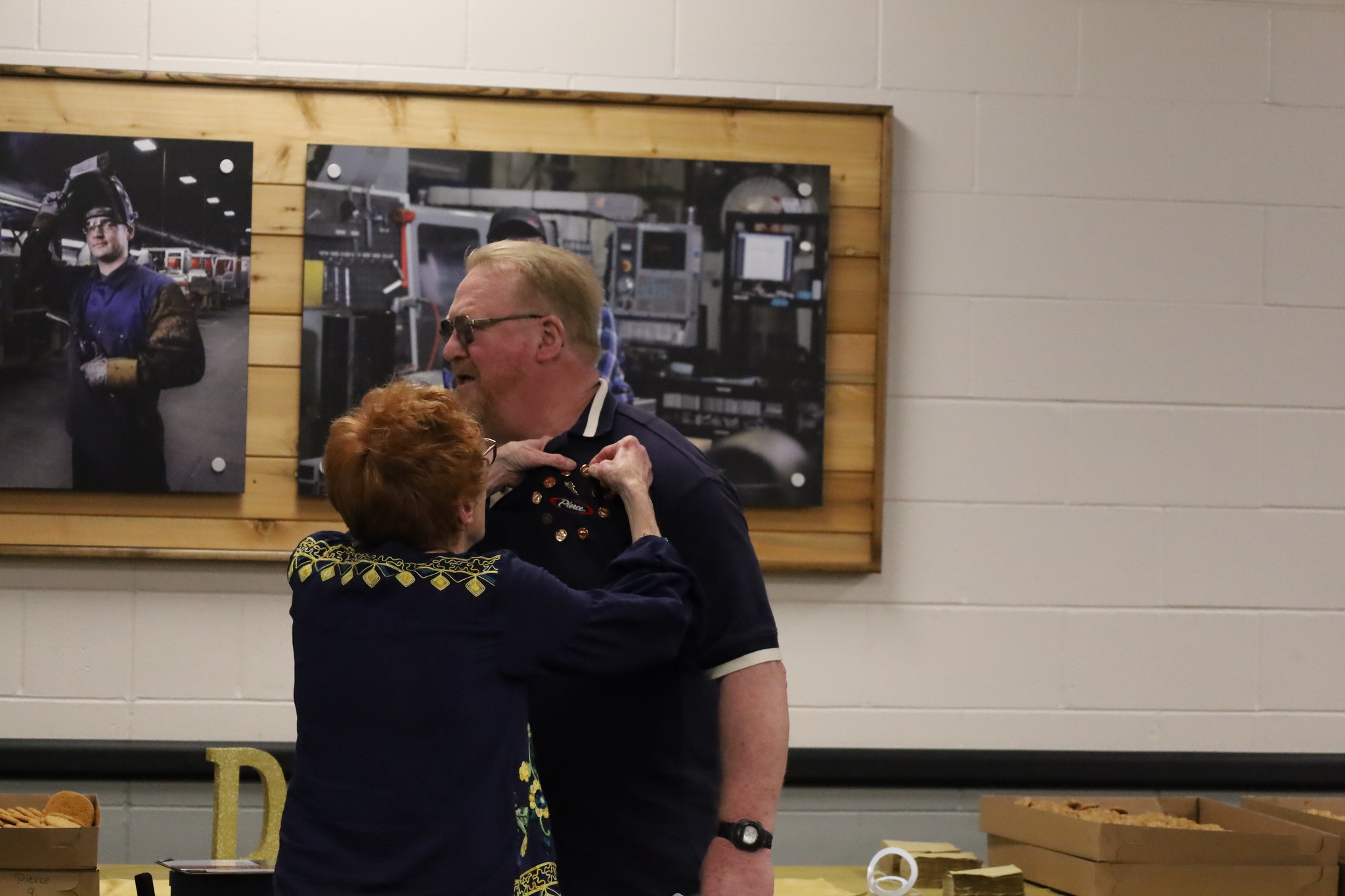 A 50-year pin is given to Dan Gensler, the first earned by a Pierce Mfg. employee.