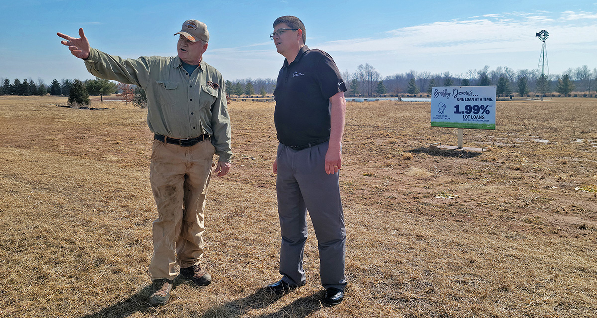 Jim Clegg of James Land Co. shows Jason Bloxham, executive vice president — chief lending officer of Wolf River Community Bank, available lots in Phase II of the Wildwind subdivision in Hortonville.