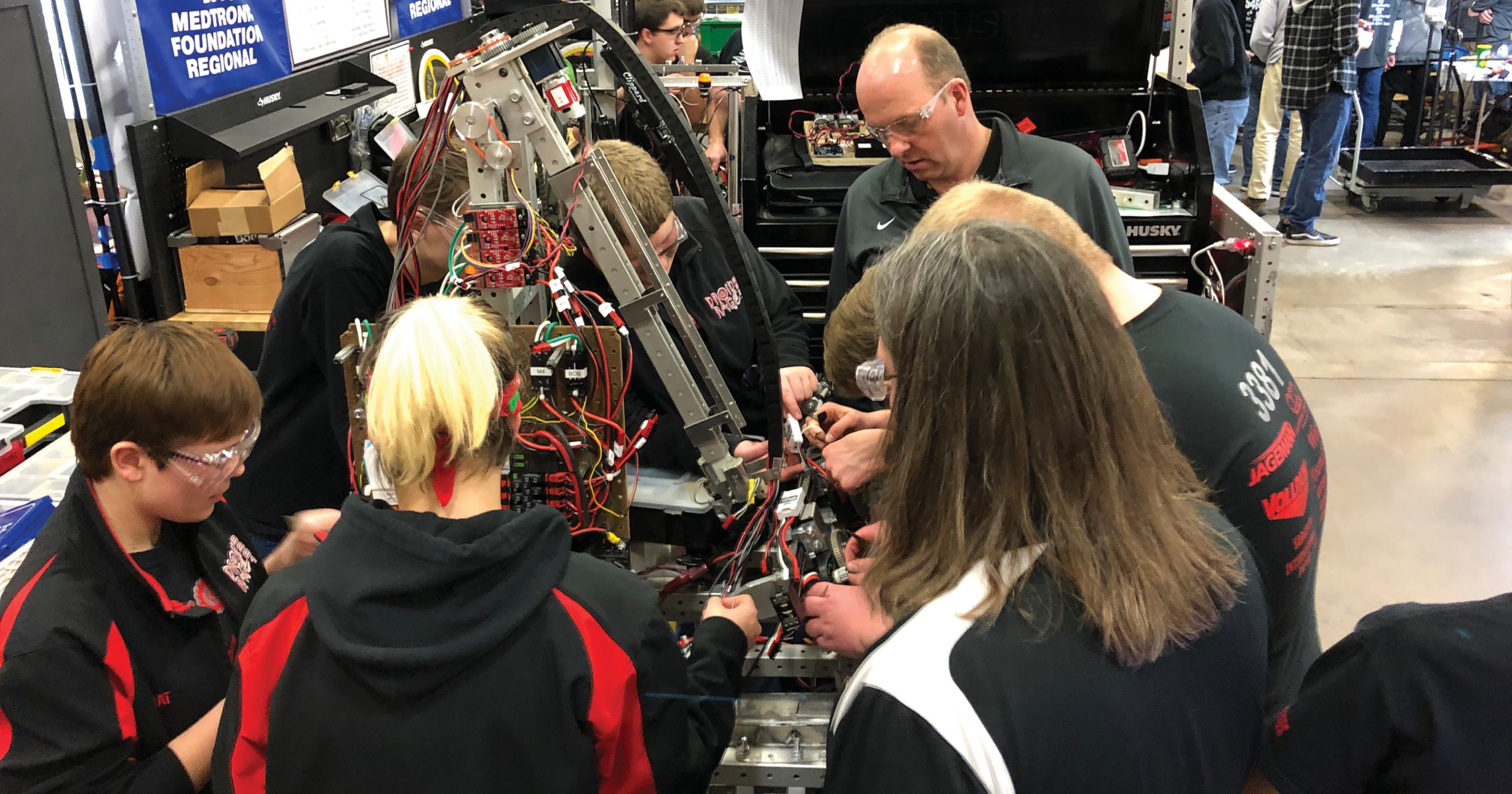 Dozens of volunteer mentors with experience in STEM professions guide  Lakeshore FIRST Robotics participants. Mentors encourage students to problem-solve through asking questions.