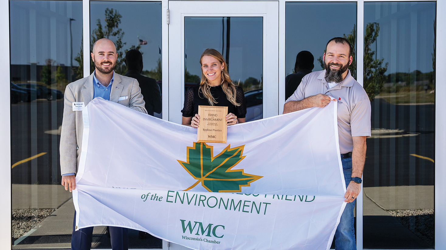 Redline Plastics is presented the 2024 Business Friend of the Environment Award by Wisconsin Manufacturers & Commerce. From left: Adam Jordahl, Director of Environmental & Energy Policy; Annie Baeten, Redline Marketing Manager; Nick Murray, Redline President