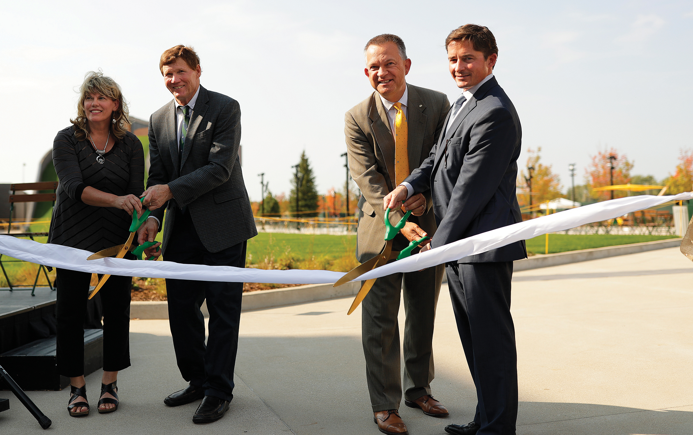 Village of Ashwaubenon President Mary Kardoskee, Packers President/CEO Mark Murphy, Baniel, and Packers COO and General Counsel Ed Policy cut the ribbon to the public plaza at Titletown Sept. 15, 2017.
