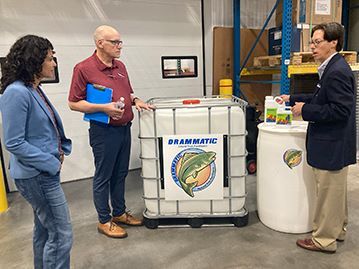Hans, right, and Fritz Dramm, middle, speak with USDA Deputy Secretary Xochitl Torres Small.