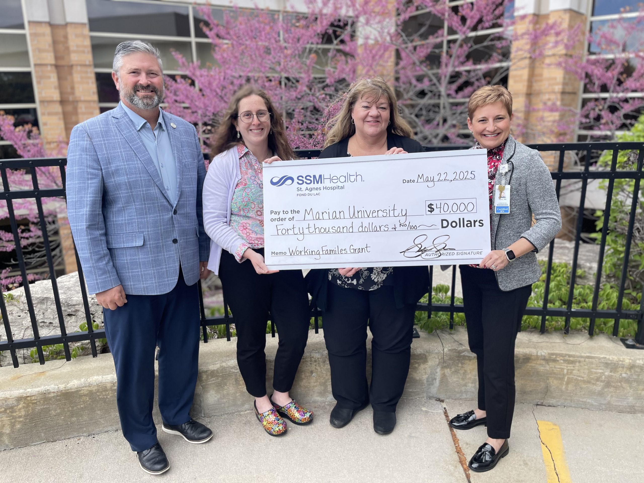Tami Schattschneider (right), SSM Health St. Agnes Hospital Patient Care Services vice president/chief nursing officer, and Laura Nakielski, SSM Health senior community health specialist (second from left), presents a $40,000 gift to support the Marian University Working Families Grant program. The donation was received by Aaron Sadoff (left), president of Marian University, and Kerry Strupp (center), Marian University’s director of the Working Families Grant.