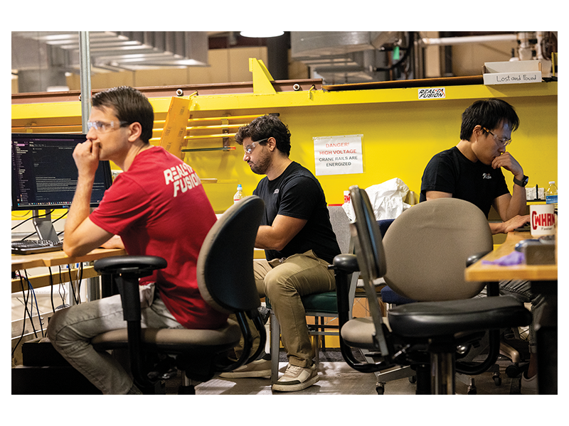 UW's Dmitry Yakovlev works with Realta's Leonardo Reis and Kai Shih.