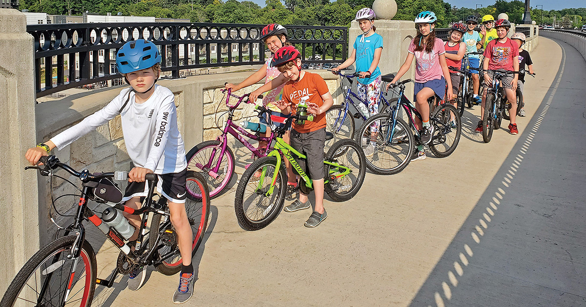 Students in the Wisconsin Bike Federation’s urban riding class cross the College Avenue bridge in Appleton. Michelle Bachaus, community engagement manager, says she is able to conduct the class safely because of the city’s commitment to bike friendliness and protected bike lanes.