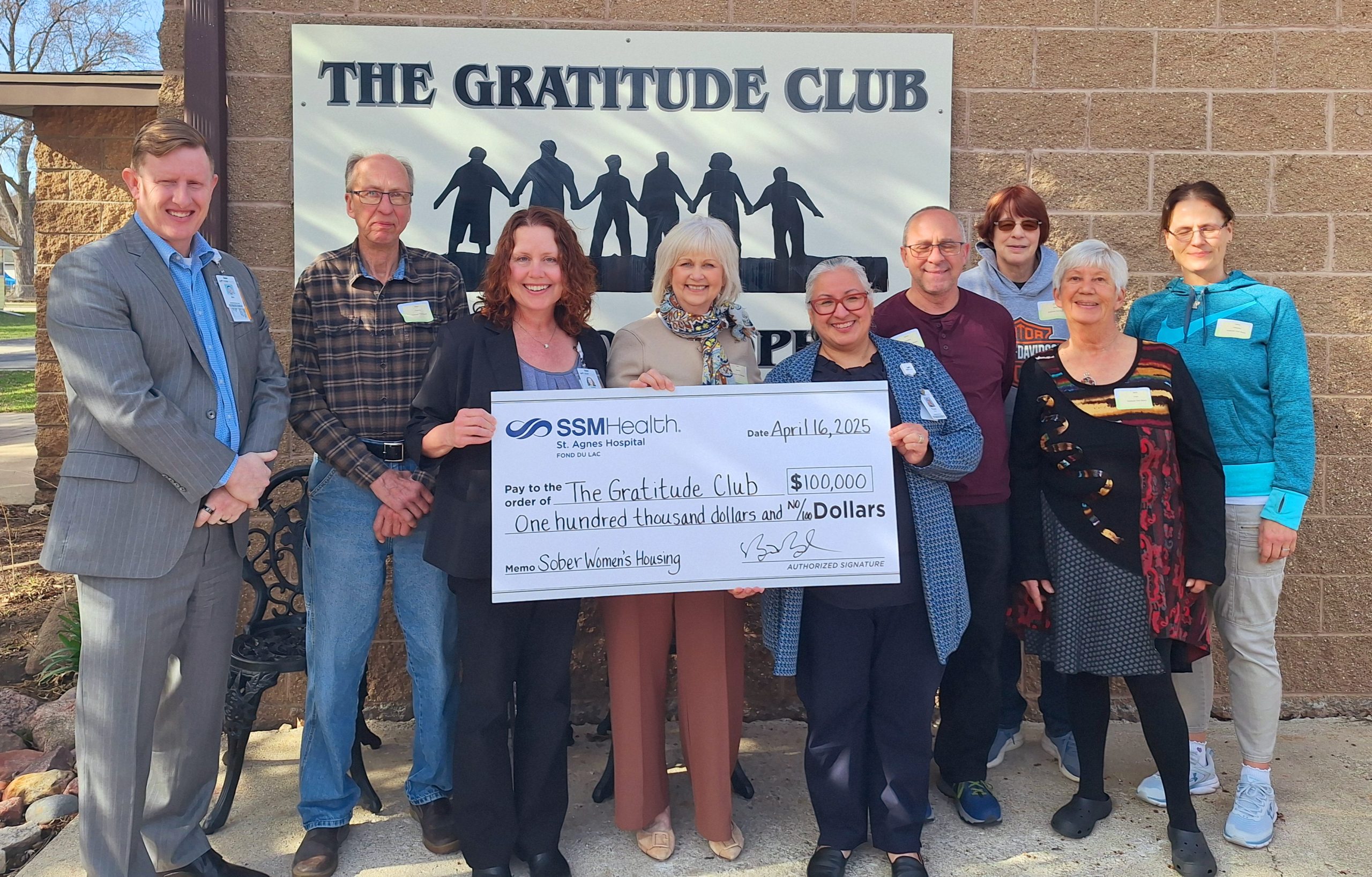 Bill Boyd (left), SSM Health St. Agnes Hospital vice president of operations, Dr. Jamie Deering (third from left), SSM Health Wisconsin Region Primary Care medical director, and Rosie Perez (fifth from left), SSM Health Wisconsin Region VP Mission Integration, present a $100,000 gift to support The Gratitude Club to support a new women’s sober living residence. Receiving the donation are (left to right) Dave Twohig, Ellen Buretta, Steven Kohnke, Diane Martin, Barbara Fitch, and Debra Casetta.