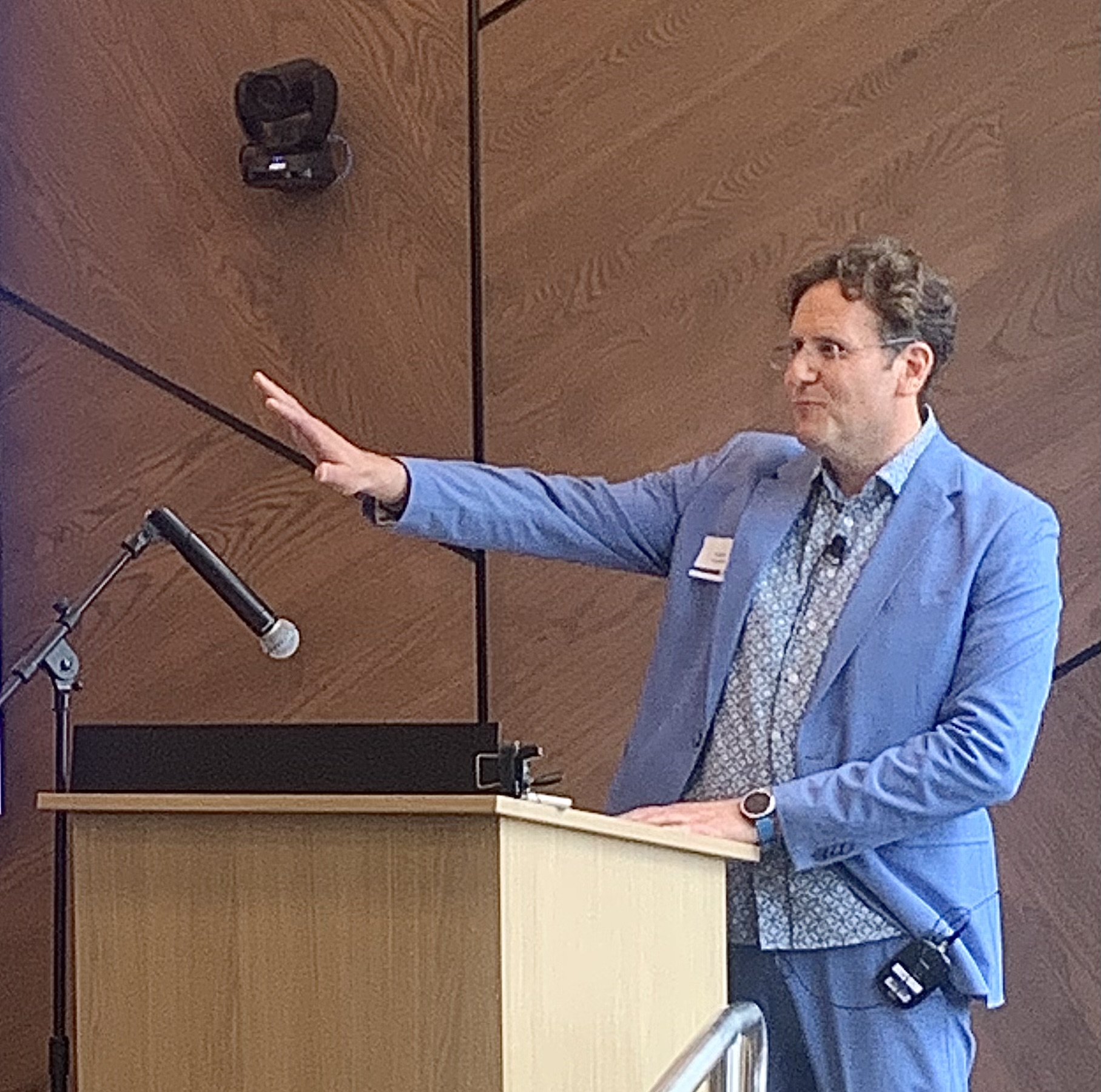 Professor Adam Galambos gestures while speaking during the opening of the Lawrence University Business & Entrepreneurship Center at Fox Commons in downtown Appleton.