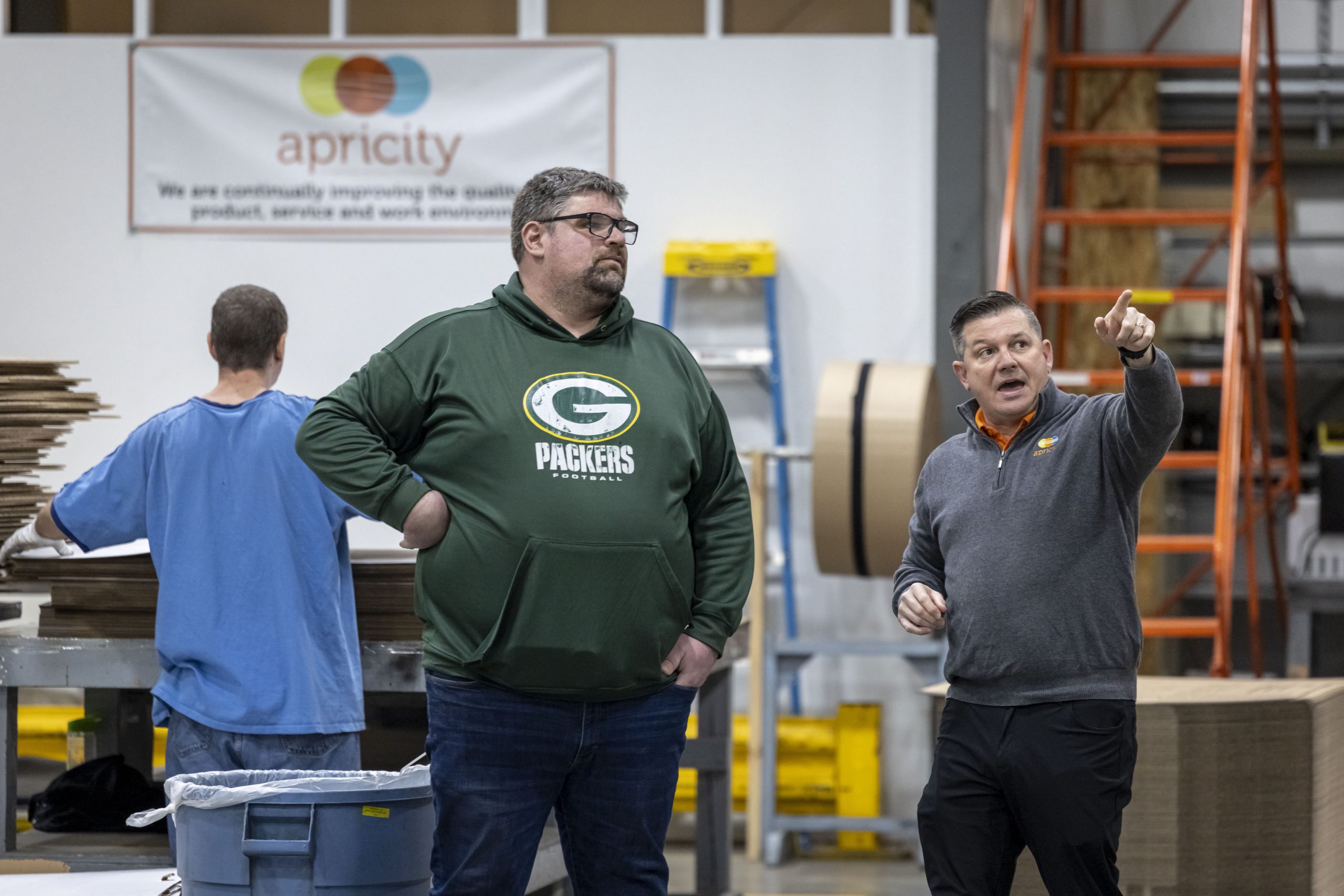 Andy Geurden, left, a team leader at Apricity Contract Packaging, talks with company President Dan Haak as they tour the production floor in Appleton, on Jan. 26.