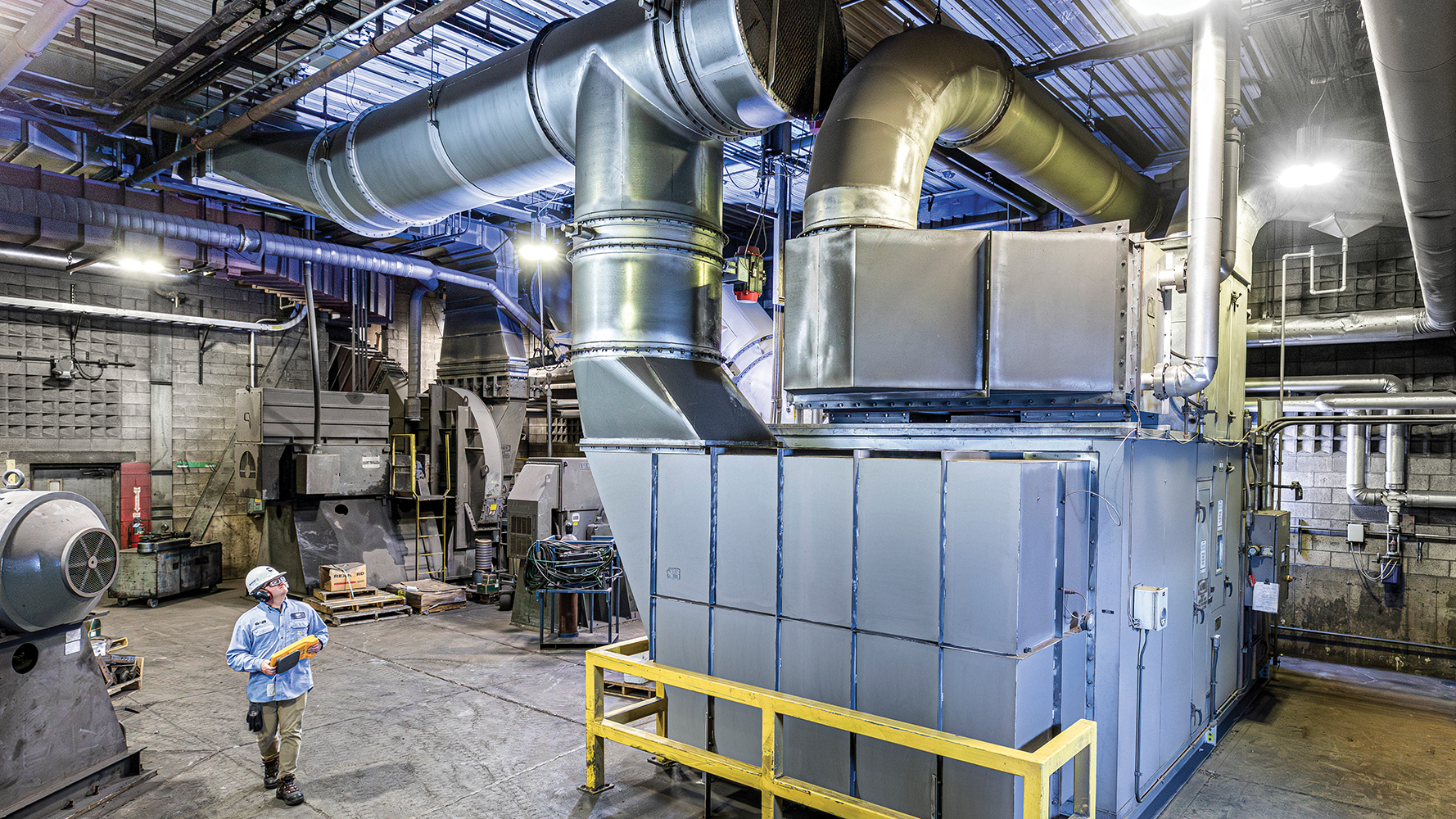 Waupaca Foundry Environmental Engineer Curtis Viet inspects the dehumidification system at the supplier’s Plant 2/3 gray iron foundry.