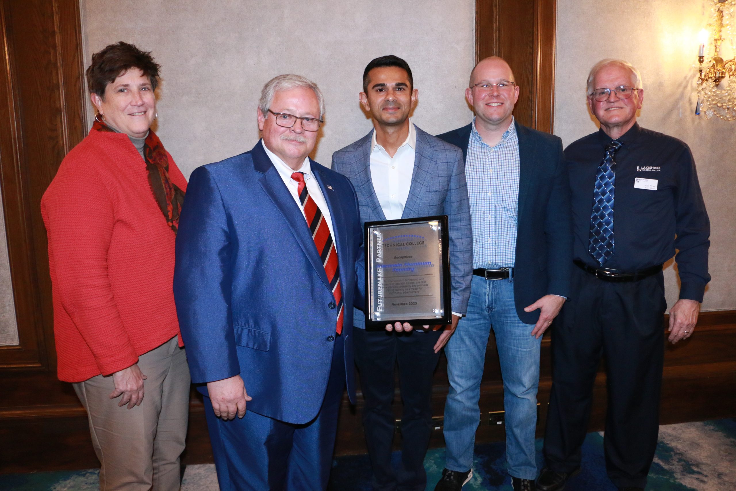 A Wisconsin Technical College System Futuremaker Partner Award was presented to Wisconsin Aluminum Foundry during a celebration held November 7. Pictured from left to right: Morna Foy, WTCS president; S. Mark Tyler, WTCS board president; Sachin Shivaram, Wisconsin Aluminum Foundry CEO; Paul Carlsen, Lakeshore Techical College president; and John Wyatt, Lakeshore Technical College board chair.