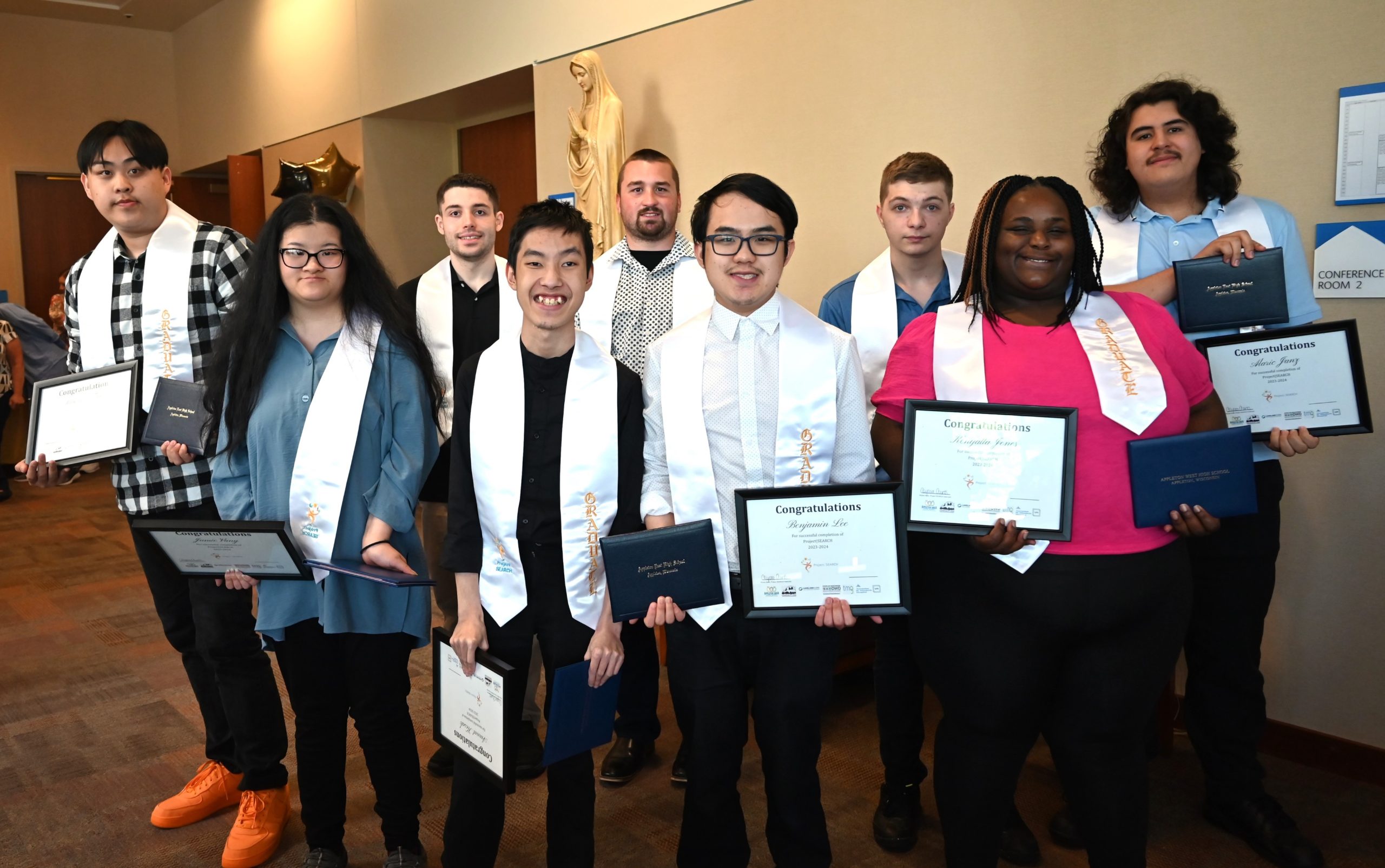 Project SEARCH graduates at the graduation ceremony at Ascension St. Elizabeth on May 23 in Appleton, marking the completion of a nine- to 12-month immersive work experience. In back, from left are Max Thao, Ethan Treleven, Gavin Meitner, Alec McCoy, Alaric Janz; In front, from left are Jamie Vang, Amnat Kosak, Benjamin Lee, Kenyatta Jones