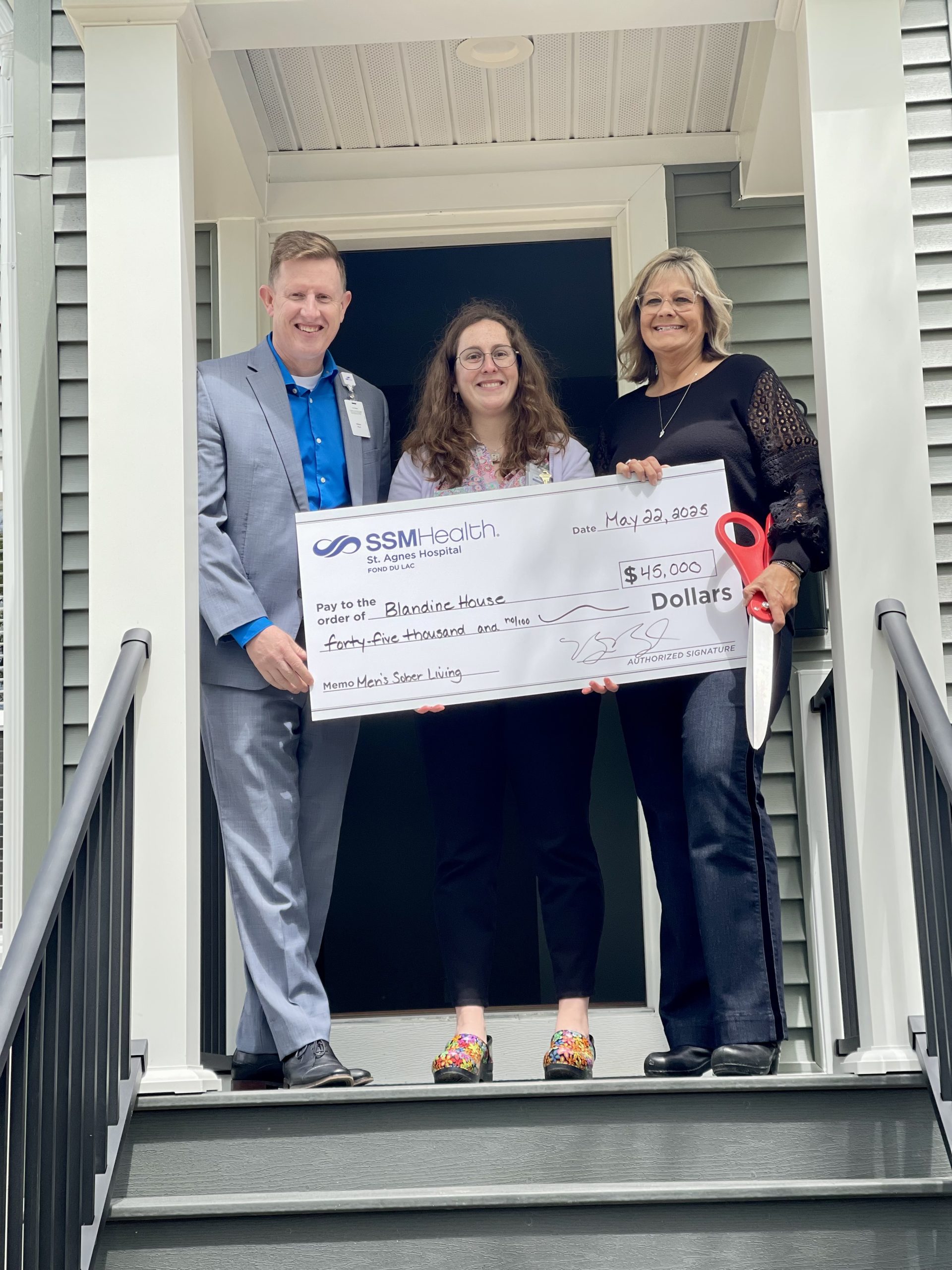 Bill Boyd (left), SSM Health St. Agnes Hospital vice president of operations, and Laura Nakielski (center), SSM Health senior community health specialist, present a $45,000 donation to Julie Feilbach (right), Blandine House executive director.