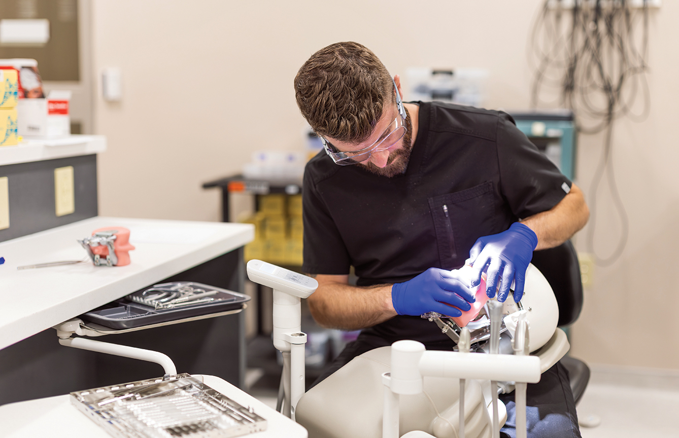 FVTC students working in dental labs on practice teeth.