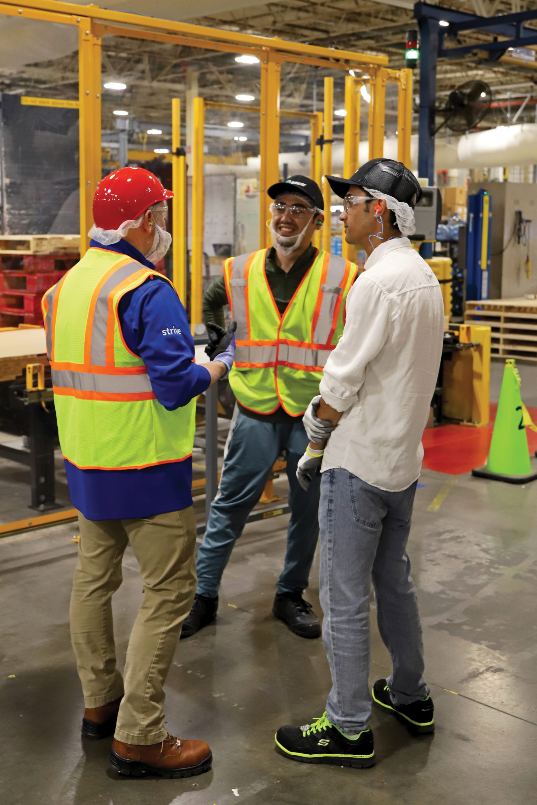 In his role as training coordinator, Ramish Majidi (r) helps facilitate conversations between refugee employees and other team members.