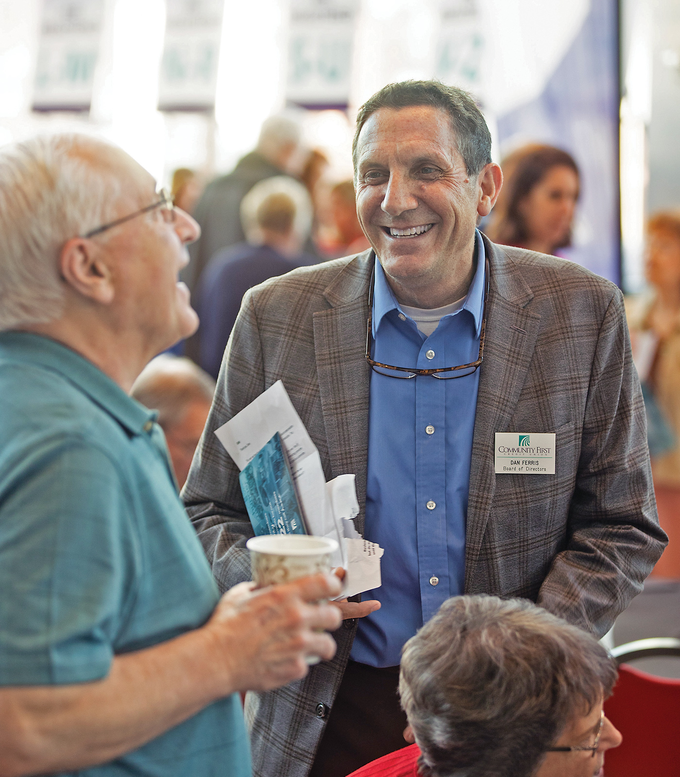 Board Member Dan Ferris enjoys a moment with a member at the May 2024 Annual Meeting. Each year, more than 1,000 member owners gather to learn about their credit union’s performance and plans, and to cast their vote in the Board of Directors election.