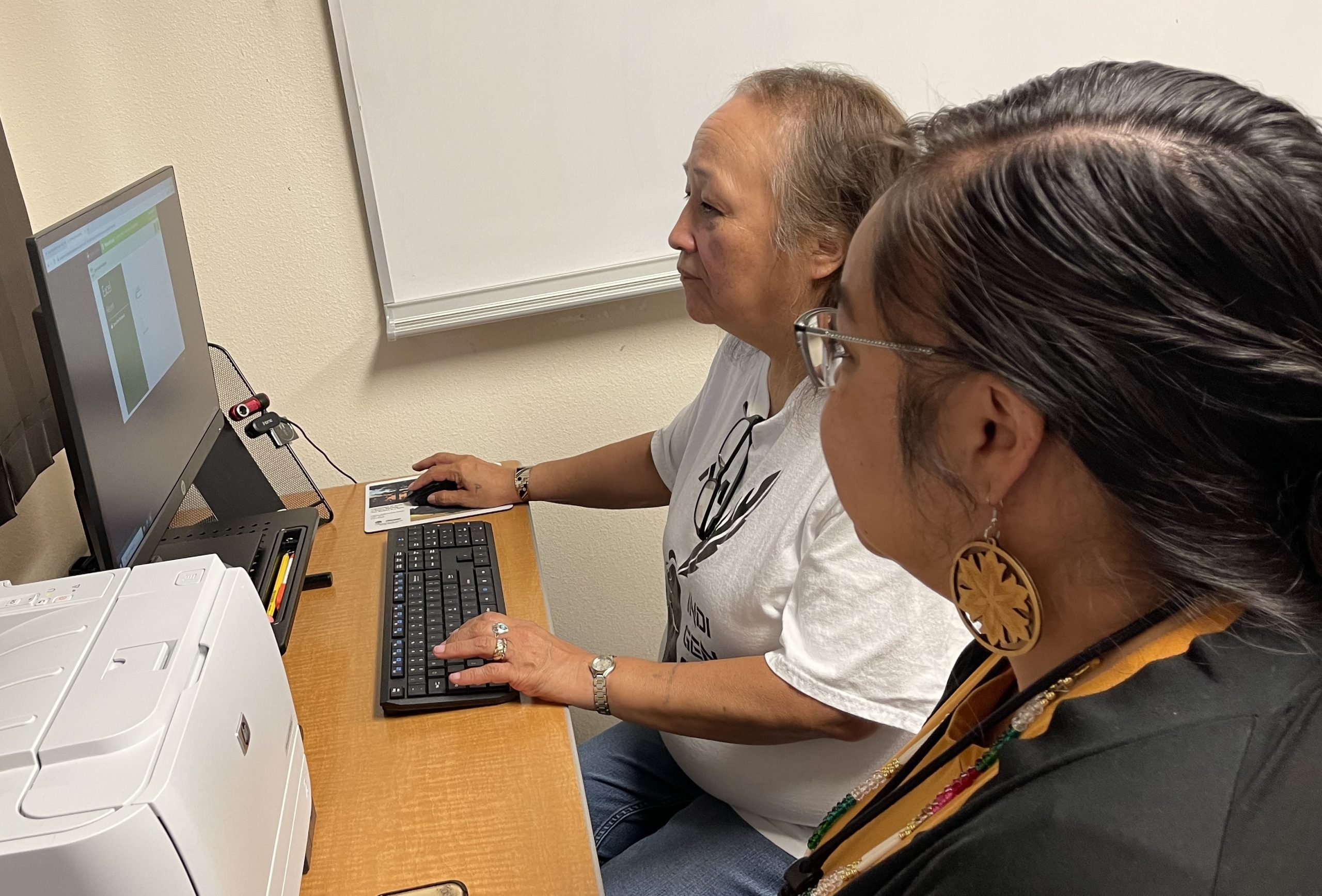 Tasha Komaneikin, right, and Joyce Pamonicutt work at a computer at College of Menominee as part of the NEW BOOST for Hidden Talent program July 26, 2023.