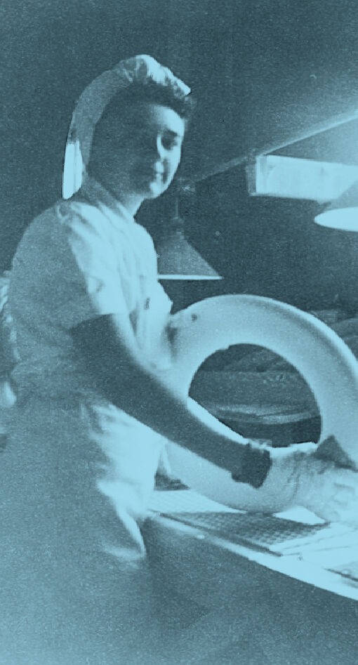 Bemis employee Virginia Bonnet, circa 1948, hand sands a toilet seat ring.