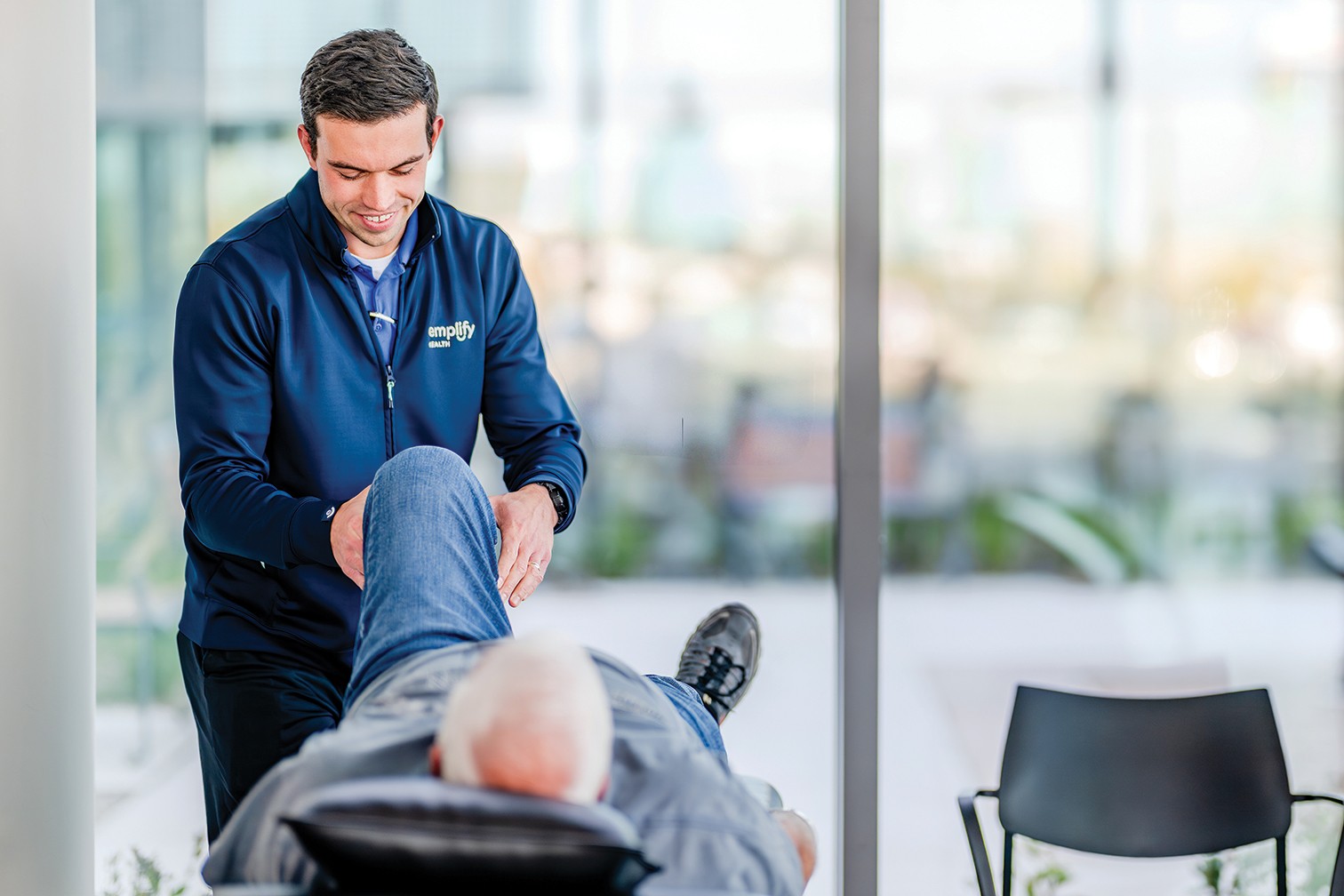 Physical therapist David Rader works with patients at an Emplify Health by Bellin Primary Care clinic.