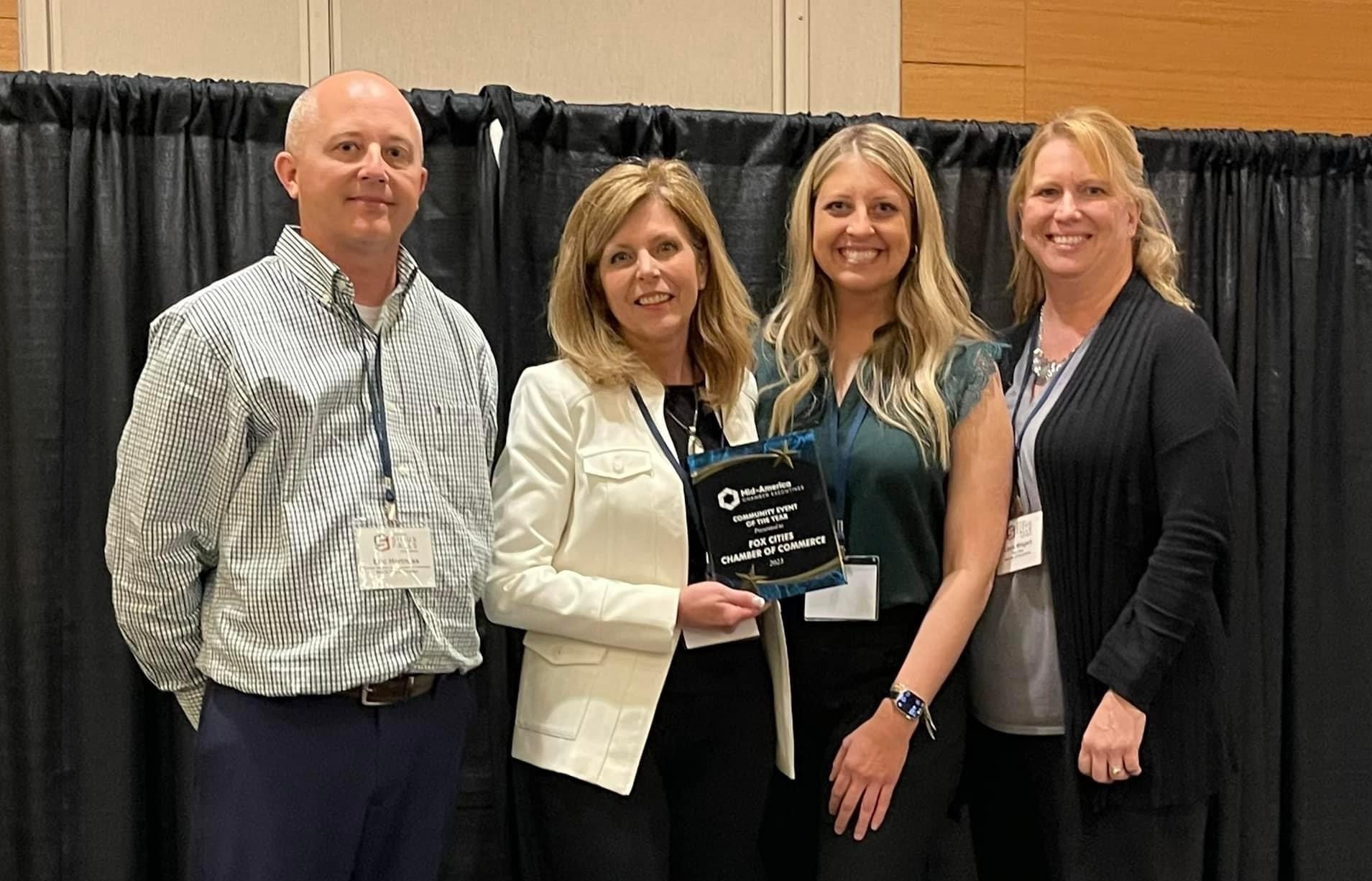 Representatives from the Fox Cities Chamber accepted the Community Event of the Year award at the Midwest America Chamber Executives conference last week in Sioux Falls, South Dakota. Pictured are, left to right, Eric Hortness, Executive Director of the Greater Madison Area (South Dakota) Chamber of Commerce and current chair of MACE, presenting the award to Becky Bartoszek, Fox Cities Chamber President and CEO; Aimee Herrick, Director of Events and Emerging Talent; and Laura Wiegert, Executive Vice President – Marketing & Events.
