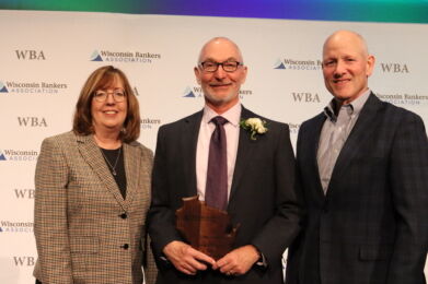 Corey Chambas (center) accepts his award from WBA President and CEO Rose Oswald Poels and 2024 Banker of the Year Kenneth Thompson