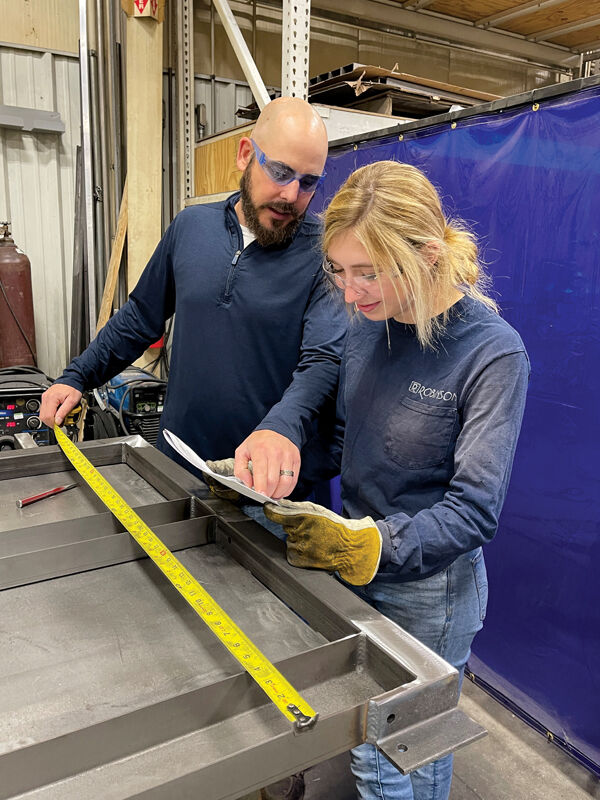 Ava Ayala, a West De Pere High School student, works with Jesse Stroka of Robinson Inc. Ayala is part of the Earn & Learn program through Fox Valley Tech, which allows students to work part time while pursuing a degree in a manufacturing field.