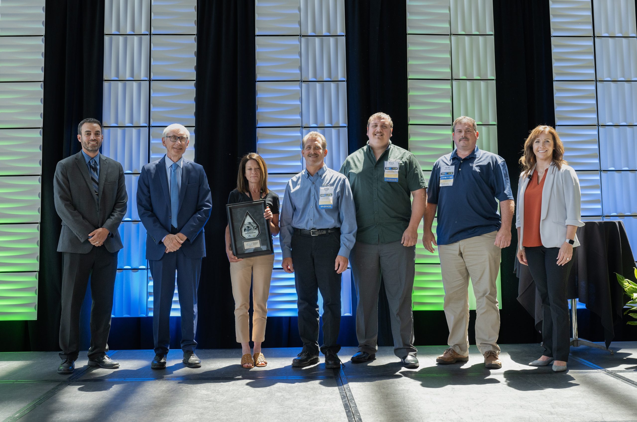 From left are Ryan Burzinski of judging committee and Schneider National, Wisconsin Gov. Tony Evers, Michelle Szymik of Wisconsin Aluminum Foundry, Gregg Rabe of Wisconsin Aluminum Foundry, Shane Chase of Wisconsin Aluminum Foundry, Scott Chervenka of Wisconsin Aluminum Foundry, Lisa Smith of award sponsor Keystone Partners