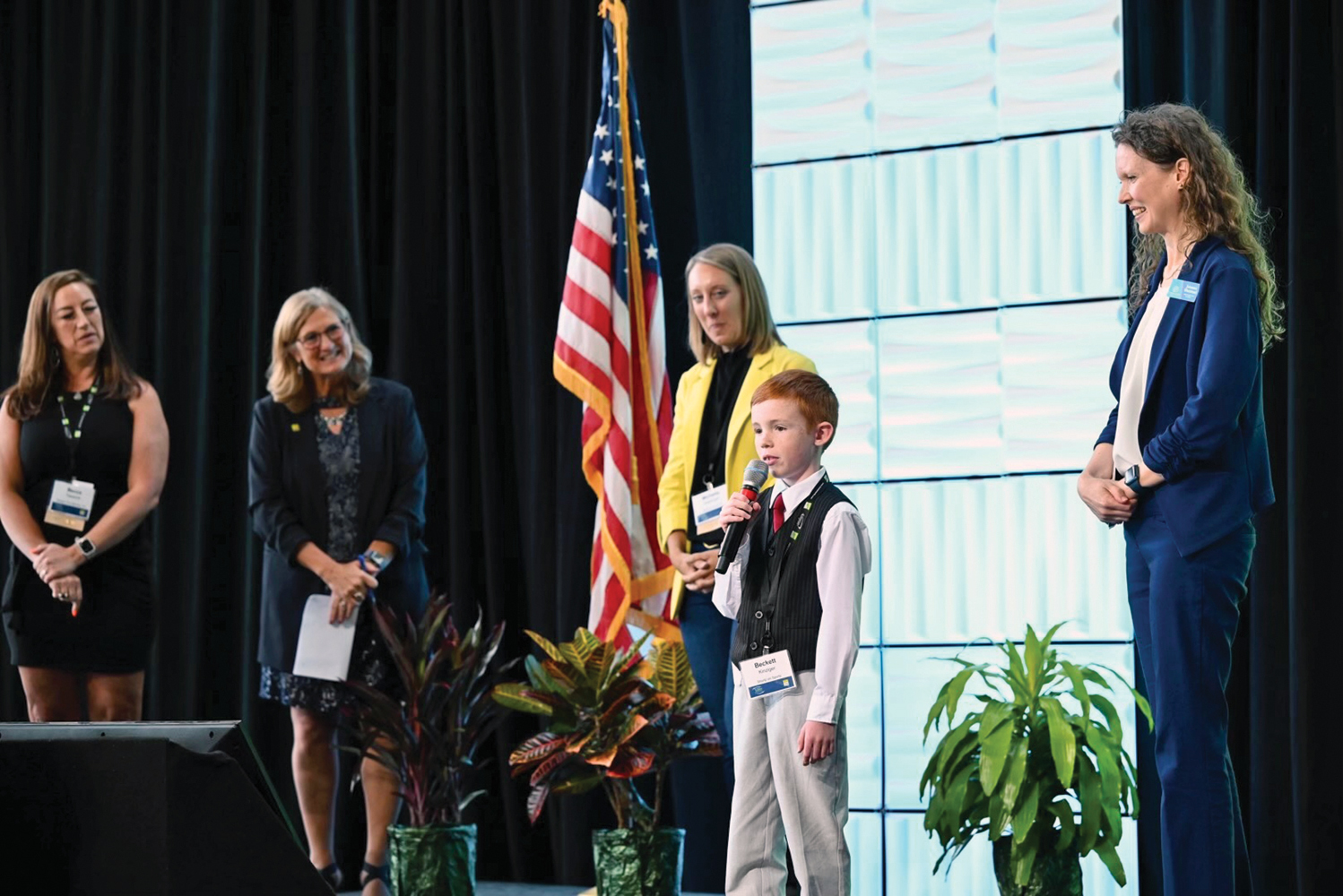 Beckett K., host of “Shortz on Sportz,” a video podcast produced by members of the Boys & Girls Clubs of the Bay & Lakes Region, addresses attendees at the New North Summit.