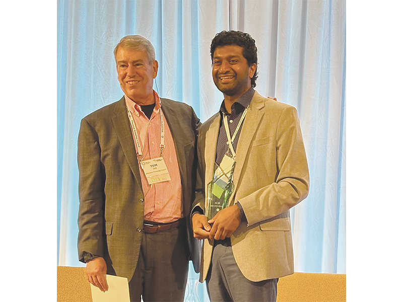 Tom Still (left), now the former president of the Tech Council, which produces the Governor's Business Plan Contest, congratulates Karthikeyan.