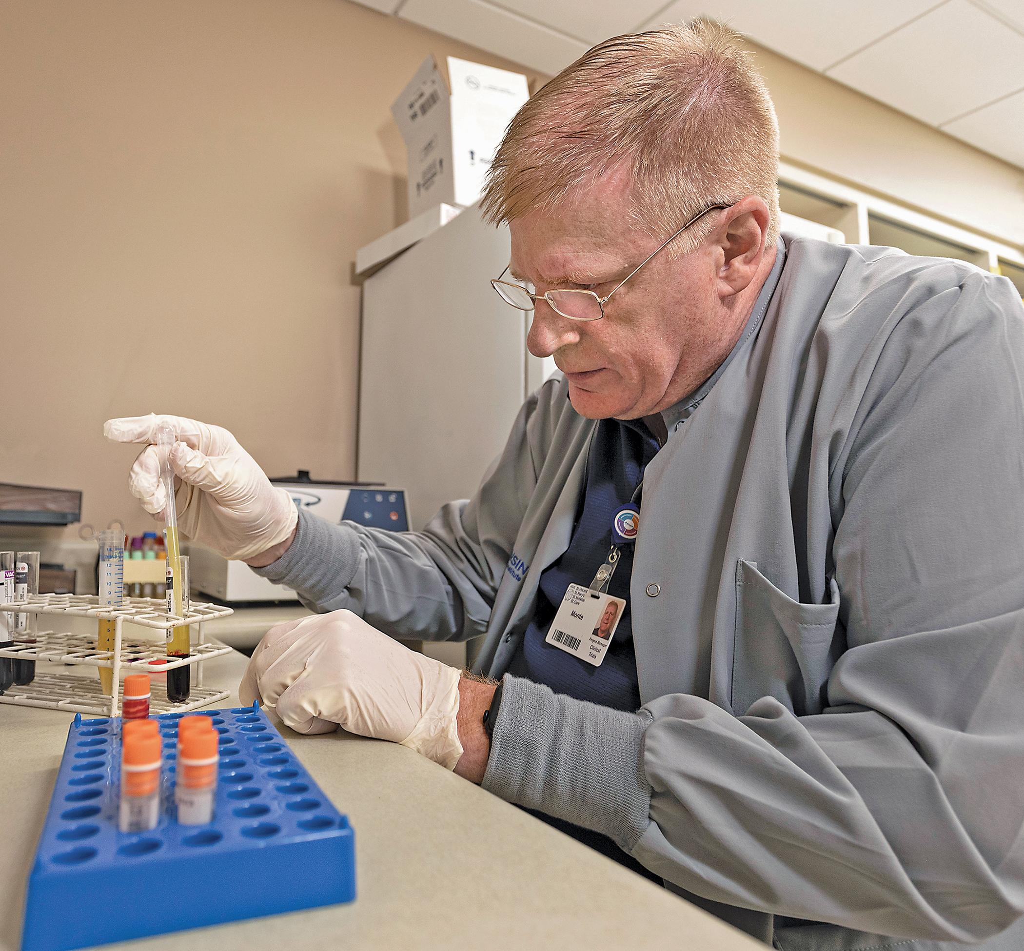 HSHS St. Vincent Clinical Research Institute Project Manager Monte White prepares blood samples to be sent for further testing as part of a clinical cancer trial.