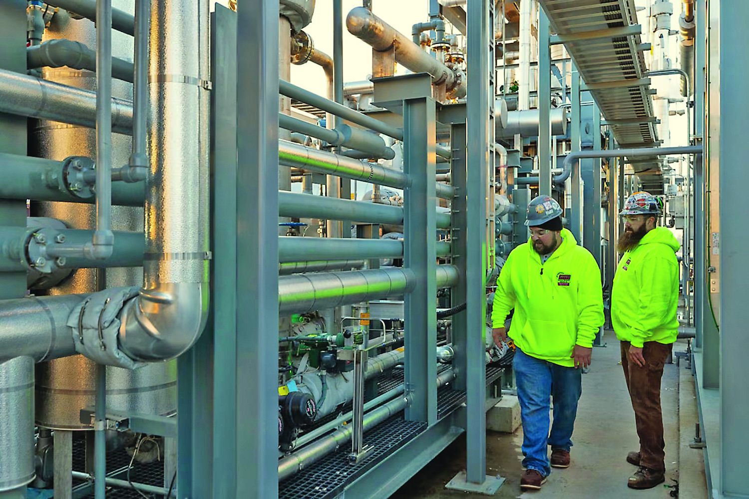 Hurckman employees reviewing piping system
