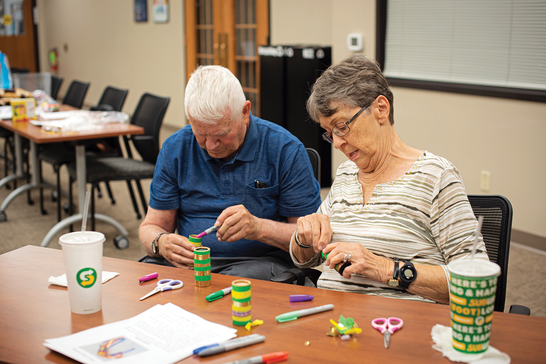 Two participants make crafts at a special Tales and Travels program.