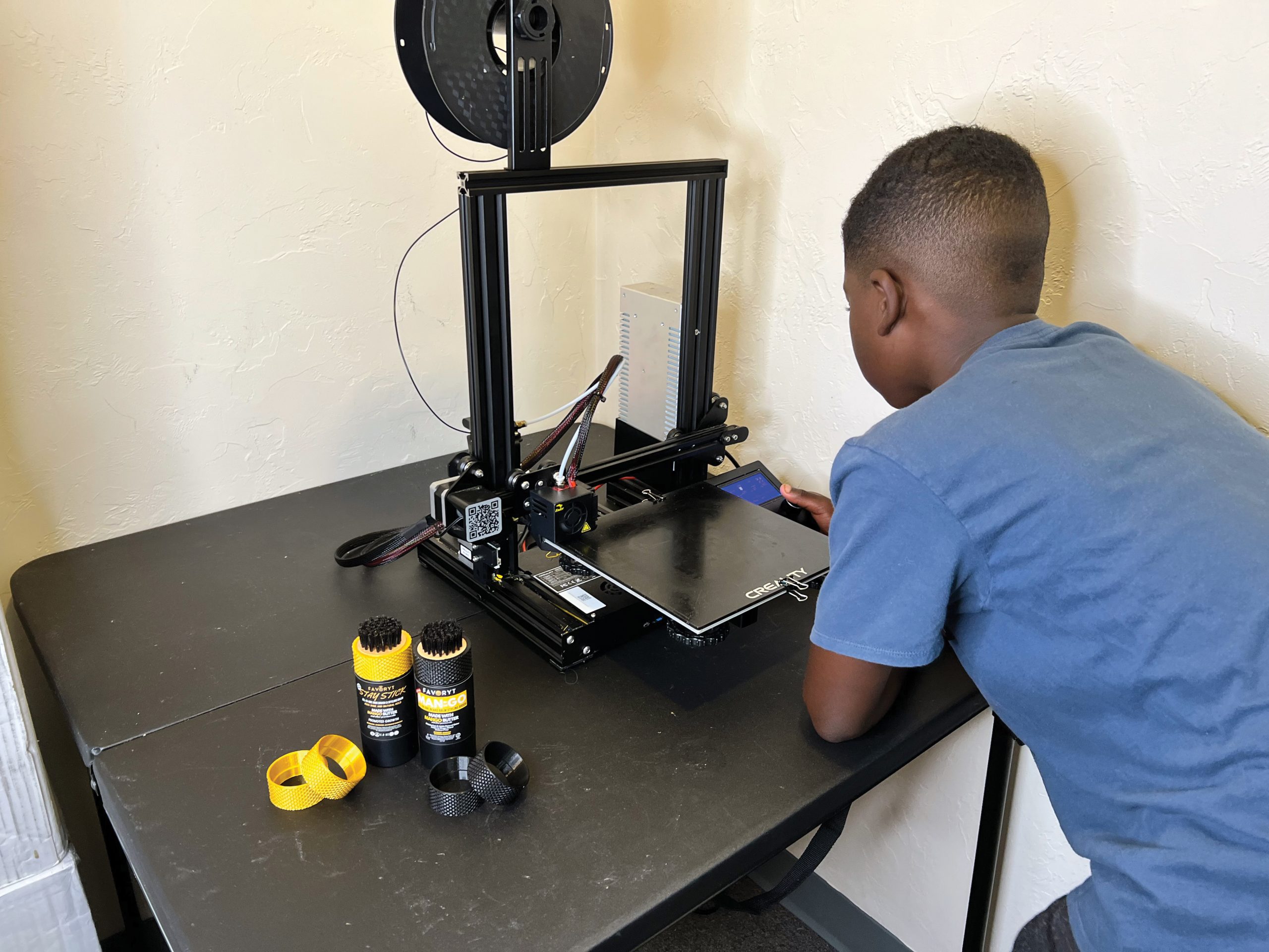 Joshua Woods Jr. operates a 3D printer for the company. FAVORYT is developing a program to loan out 3D printers to after-school programs to increase youth interest in STEM.