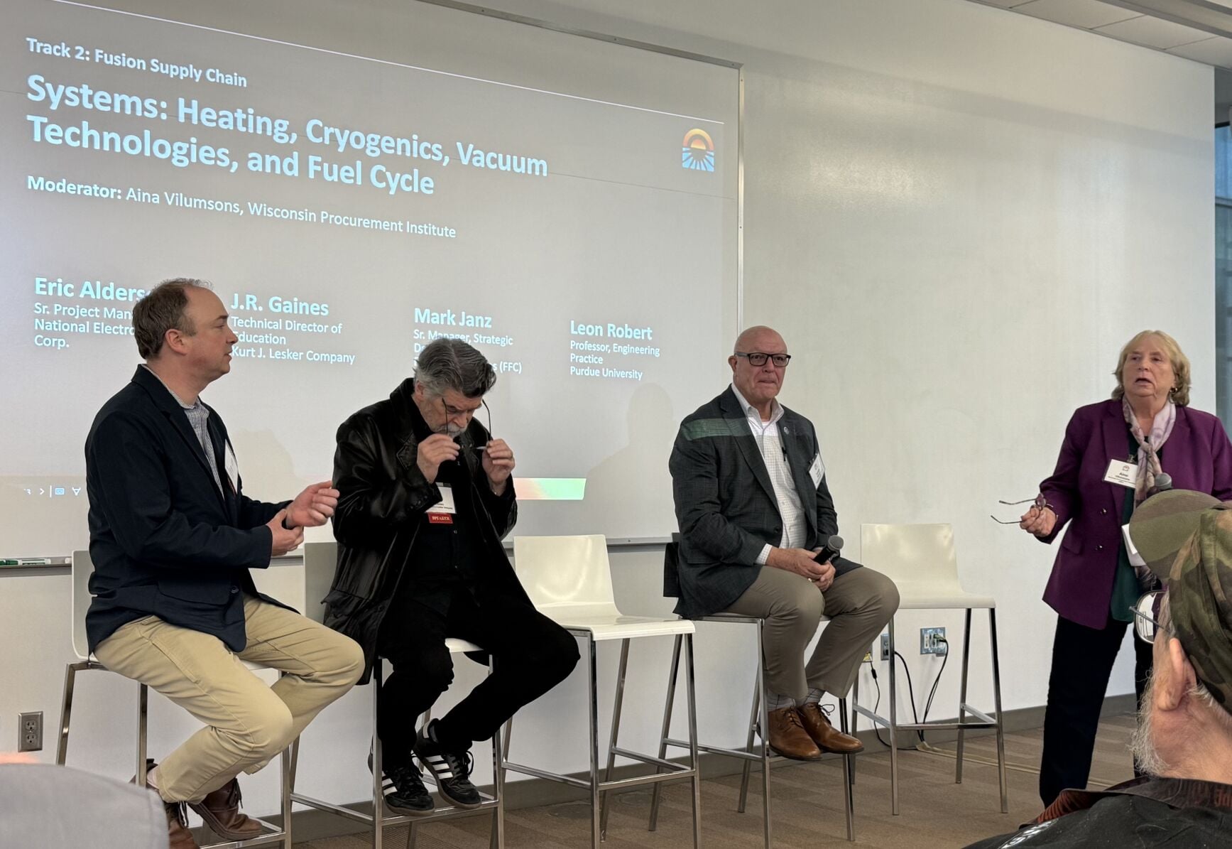 Eric Alderson (left) of National Electrostatics Corp., J.R. Gaines (second from left) of Kurt J. Lesker Co., Mark Janz (not pictured) of Fusion Fuel Cycles and Leon Robert (second from right) of Purdue University discussed