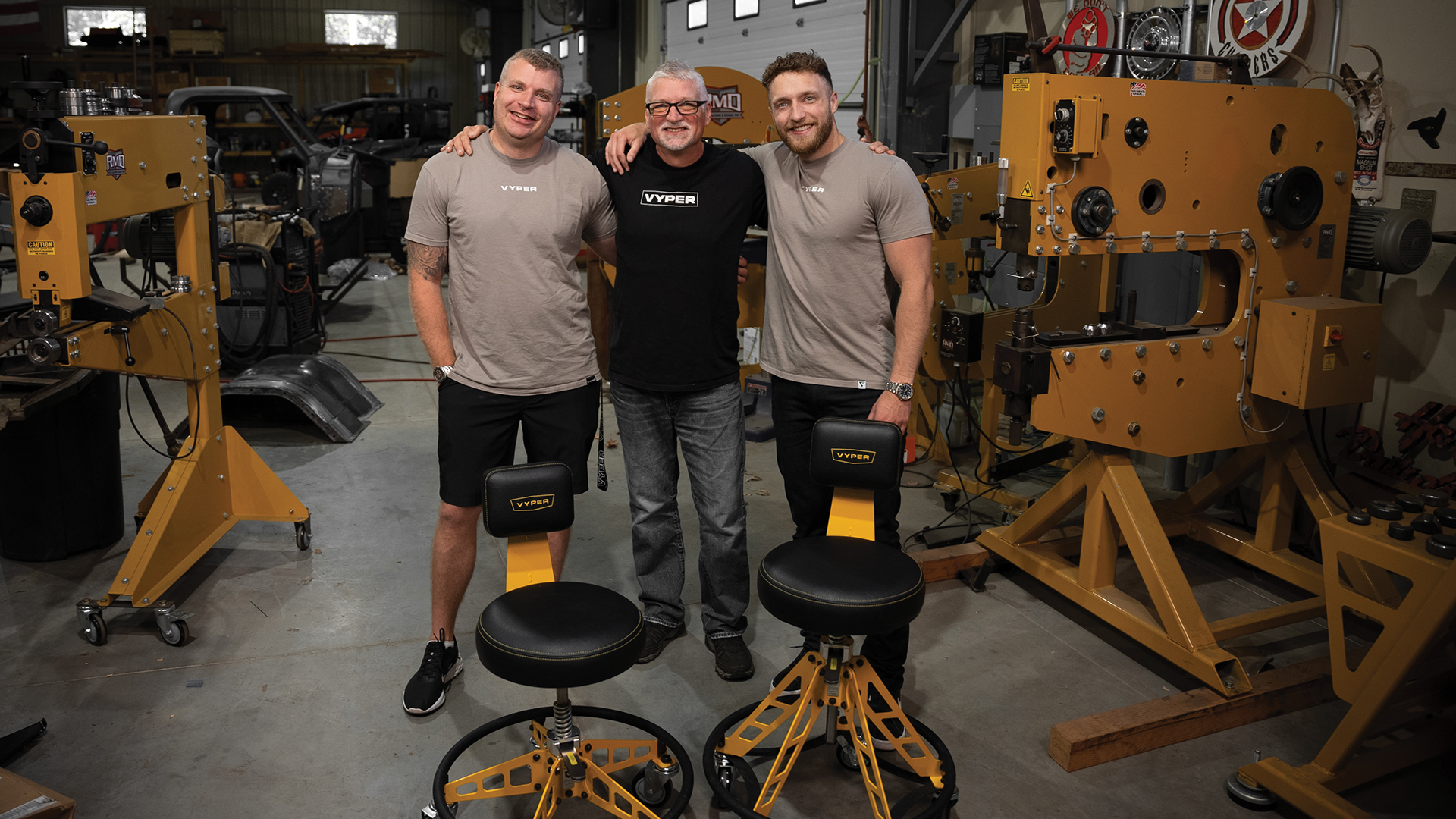 Chris Rusch (center) says he has plenty more product ideas for his sons Dylan (left) and Dayne (right), “whenever they’re ready.” The younger Rusches have built their father’s prototype for a better shop chair (above) into an eight-figure brand over the course of just five years.