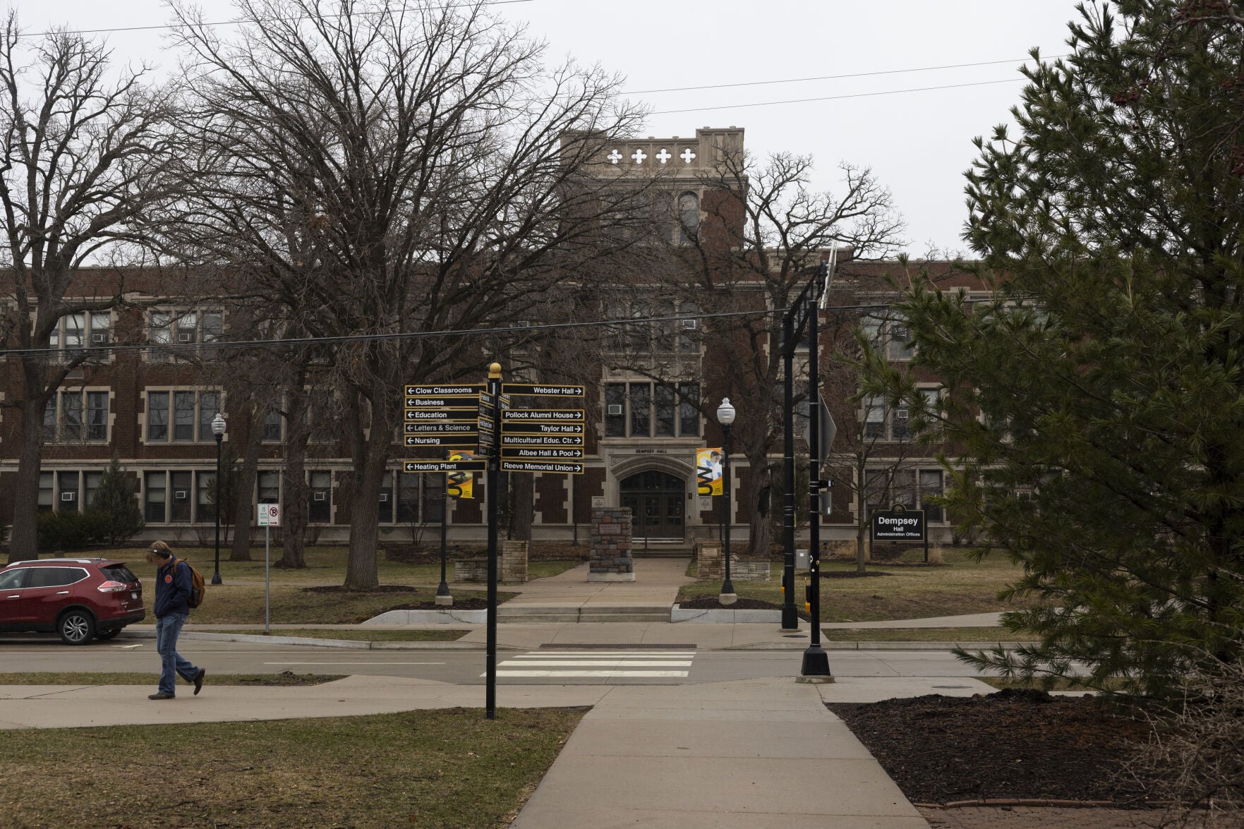 A person walks across campus on an overcast day at the University of Wisconsin-Oshkosh on March 31, in Oshkosh. Nearly half of UW-Oshkosh’s student enrollment comes from high schoolers taking college courses.