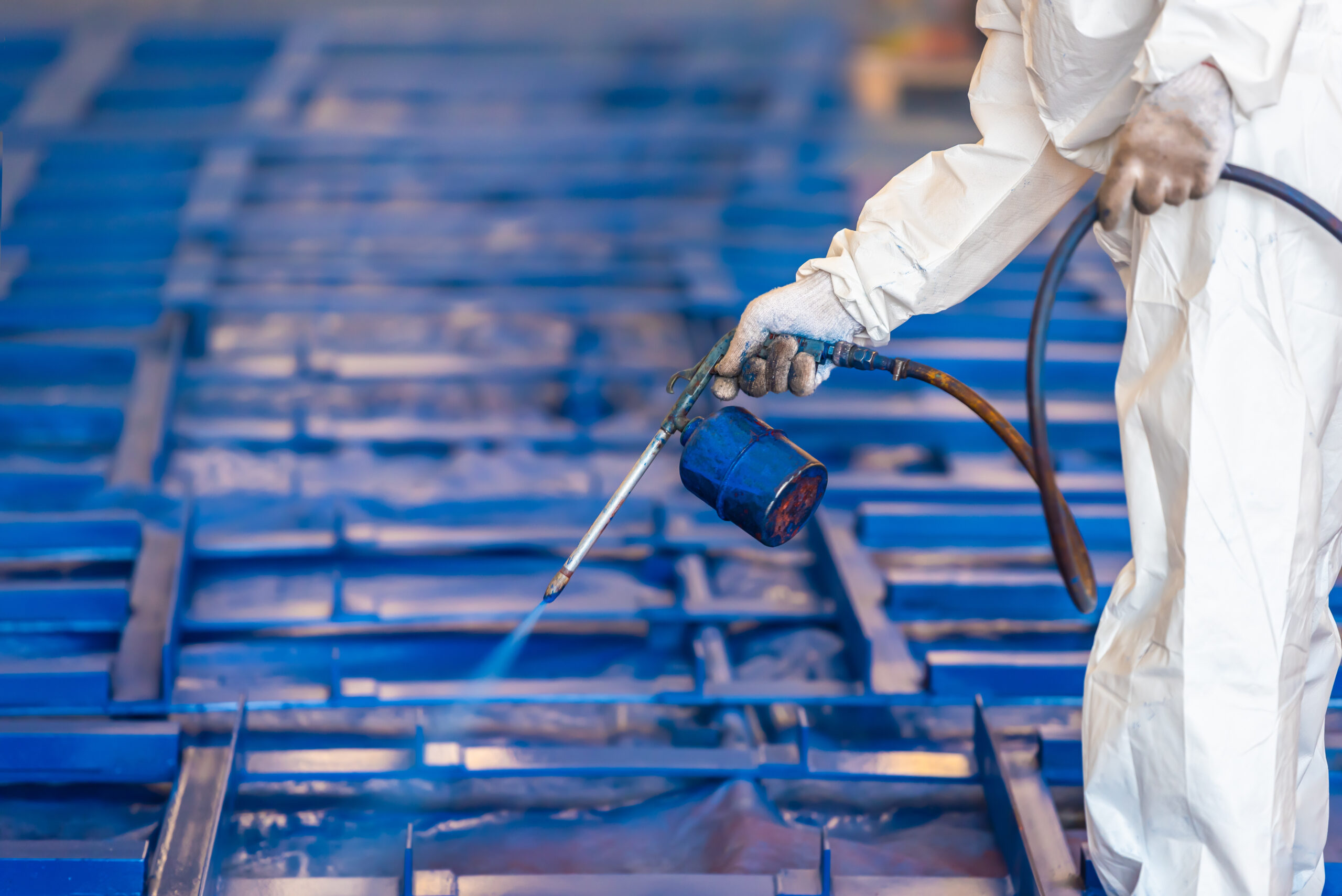 Airless Spray Painting, Worker painting on steel structure fabric